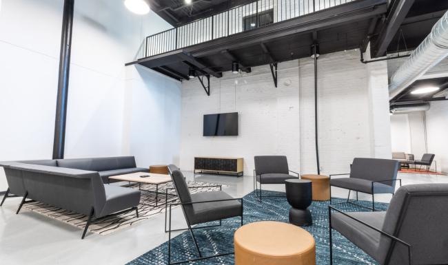 a room with a tv chairs and tables