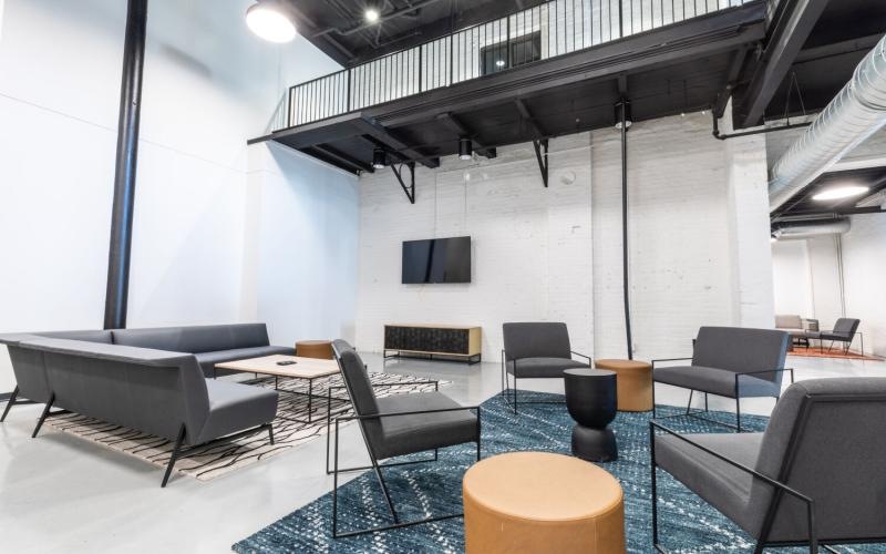a room with a tv chairs and tables